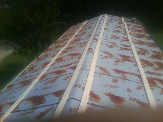 Rusted metal roof panels with new wood purlins before replacement — Storm Damage Roof Repair in Mount Airy by Roofing Brothers